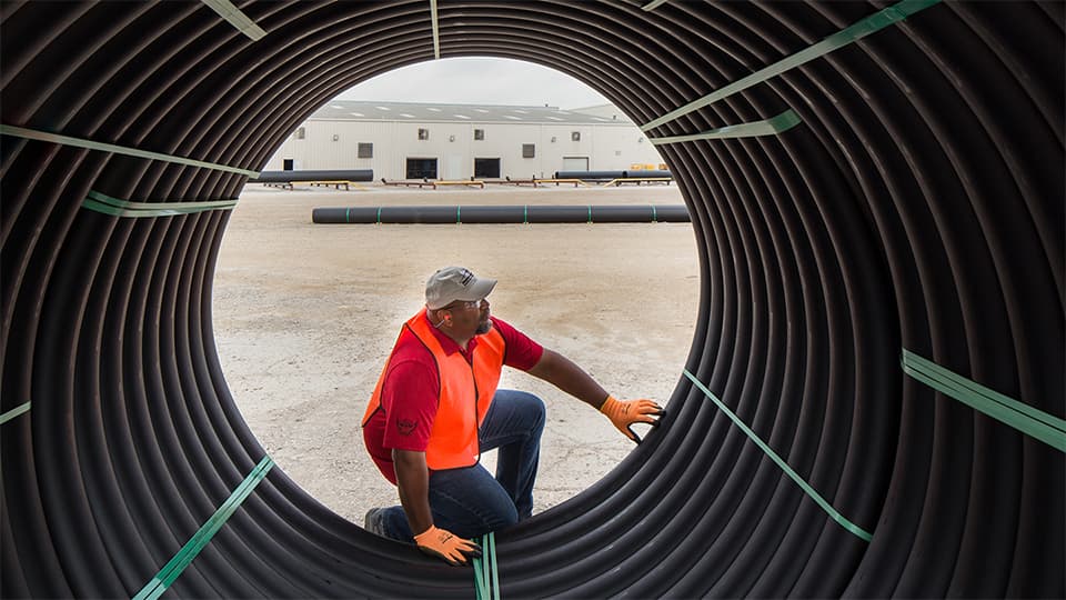 looking at a Man through the inside of a large pipe